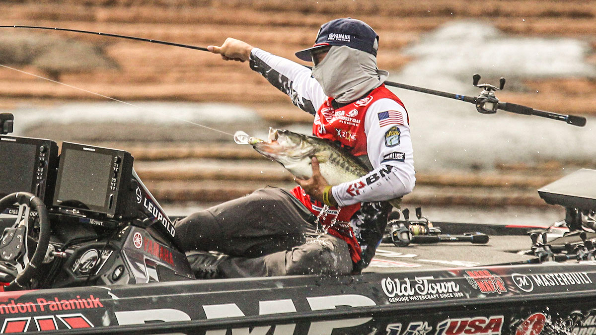 professional angler landing a largemouth bass