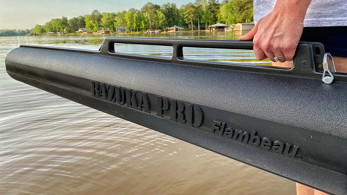 angler holding rod holder over water